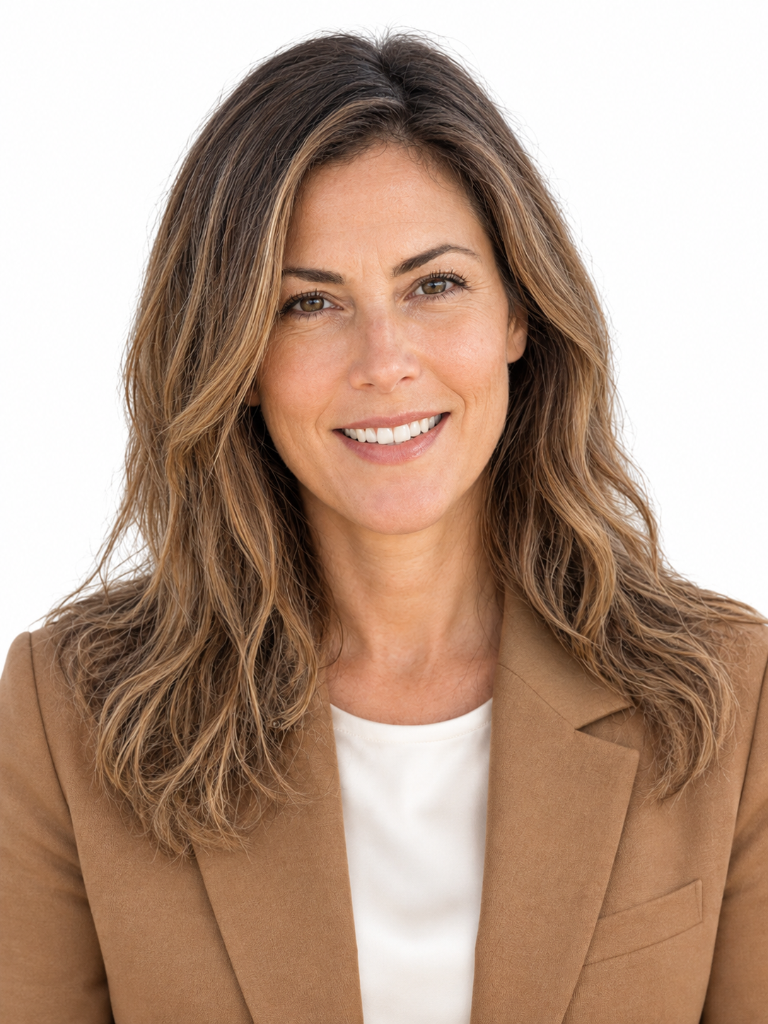 Studio headshot of the woman smiling, wearing a camel-colored tailored blazer over a white top against a clean white background.